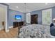 This bedroom features hardwood floors, a blue accent wall, plantation shutters, and a ceiling fan at 1531 Capel St, Mount Pleasant, SC 29466