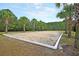 Outdoor sand volleyball court surrounded by lush greenery and trees for recreational enjoyment at 1531 Capel St, Mount Pleasant, SC 29466