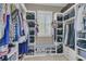 Organized walk-in closet with custom shelving, seating, and ample storage space at 1531 Capel St, Mount Pleasant, SC 29466