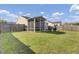 This house features a spacious backyard with a screened-in porch and a cozy fire pit area at 157 Tyger St, Summerville, SC 29485