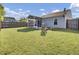 Expansive backyard with a screened porch and fire pit seating area perfect for outdoor entertaining at 157 Tyger St, Summerville, SC 29485