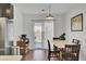 Bright dining area with sliding glass doors to backyard, wooden chairs, and modern pendant light at 157 Tyger St, Summerville, SC 29485
