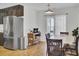 Bright dining area with sliding glass doors to backyard, wooden chairs, and modern pendant light at 157 Tyger St, Summerville, SC 29485