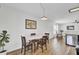 Bright dining area with modern lighting, wood floors, and access to living area, providing a cozy atmosphere at 157 Tyger St, Summerville, SC 29485