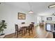 Bright dining area with modern lighting, wood floors, and access to living area, providing a cozy atmosphere at 157 Tyger St, Summerville, SC 29485