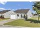 Charming single-story home with a well-maintained lawn and attached garage, set under a clear blue sky at 157 Tyger St, Summerville, SC 29485