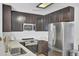 Kitchen features stainless steel appliances, quartz countertops and dark stained cabinetry at 157 Tyger St, Summerville, SC 29485