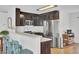 Modern kitchen with stainless steel appliances, dark wood cabinetry, and stylish breakfast bar seating at 157 Tyger St, Summerville, SC 29485