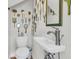 Quaint bathroom with unique mirror collection and a modern pedestal sink at 1595 Teal Marsh Rd, Charleston, SC 29412
