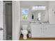 Bathroom featuring a double sink vanity with a white cabinet, complemented by wood-look vinyl flooring at 1595 Teal Marsh Rd, Charleston, SC 29412