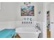 Bathroom featuring a standalone tub under a chandelier, paired with charming coastal-themed wall decor at 1595 Teal Marsh Rd, Charleston, SC 29412