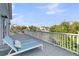 Relaxing deck area featuring a lounge chair with beautiful scenery and views of the water at 1595 Teal Marsh Rd, Charleston, SC 29412