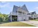 Stunning coastal home with three garage doors, a spacious covered area, and a large balcony at 1595 Teal Marsh Rd, Charleston, SC 29412