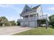 Beautiful home featuring a three-car garage, covered area, and a large balcony with lovely views at 1595 Teal Marsh Rd, Charleston, SC 29412