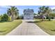 Charming coastal home with a long driveway, three garage doors, and a large balcony at 1595 Teal Marsh Rd, Charleston, SC 29412