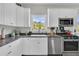 Bright kitchen featuring white cabinets, granite countertops, and stainless steel appliances at 1595 Teal Marsh Rd, Charleston, SC 29412