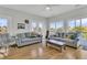 Bright living room featuring hardwood floors, comfortable seating, and access to a balcony at 1595 Teal Marsh Rd, Charleston, SC 29412
