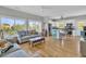 Open-concept living space featuring hardwood floors, bright lighting, and balcony access at 1595 Teal Marsh Rd, Charleston, SC 29412