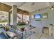View of a covered patio space with outdoor furniture, a tv, and surfboards stored underneath the house at 1595 Teal Marsh Rd, Charleston, SC 29412