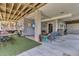 Covered patio with an outdoor seating area, television, grill, and surfboards underneath the structure at 1595 Teal Marsh Rd, Charleston, SC 29412