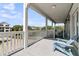 Charming covered porch featuring classic railings and comfortable seating with scenic neighborhood views at 1595 Teal Marsh Rd, Charleston, SC 29412