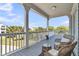 Comfortable covered porch area featuring wicker furniture, ideal for enjoying the outdoors at 1595 Teal Marsh Rd, Charleston, SC 29412