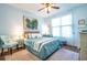 Serene bedroom with blue accents, a ceiling fan, and large windows providing plenty of natural light at 1615 Chatelain Way, Mount Pleasant, SC 29464