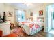 Bright bedroom featuring two beds, wood floors, and colorful floral accents for a welcoming space at 1615 Chatelain Way, Mount Pleasant, SC 29464
