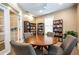 This cozy library features a round table surrounded by bookshelves, offering a quiet retreat at 1615 Chatelain Way, Mount Pleasant, SC 29464