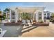This poolside lounge features lounge chairs, a shady pergola, and lush landscaping at 1615 Chatelain Way, Mount Pleasant, SC 29464