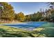 Enjoy a match on this pristine tennis court surrounded by lush greenery on a beautiful day at 1615 Chatelain Way, Mount Pleasant, SC 29464