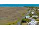 Aerial view of a waterfront home with canals and a stunning marsh view at 1676 E Ashley Ave, Folly Beach, SC 29439