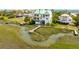 Aerial shot of beautiful home with a dock on the marsh, surrounded by lush greenery and waterfront views at 1676 E Ashley Ave, Folly Beach, SC 29439