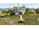 Stunning aerial view of waterfront home with private dock, beautiful landscaping and nearby beach access at 1676 E Ashley Ave, Folly Beach, SC 29439