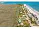 Stunning aerial view of beach homes nestled between the ocean and winding marshland at 1676 E Ashley Ave, Folly Beach, SC 29439