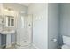 Bathroom with pedestal sink, round glass-enclosed shower and gray paint at 1676 E Ashley Ave, Folly Beach, SC 29439