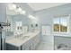 Beautiful bathroom offering double sinks, quartz countertop, and coastal view at 1676 E Ashley Ave, Folly Beach, SC 29439