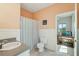 Bright bathroom with a single sink vanity, colorful shower curtain, and a view to the bedroom at 1676 E Ashley Ave, Folly Beach, SC 29439