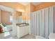 Bathroom with vanity, mirror, colorful shower curtain, and view of bedroom with bed at 1676 E Ashley Ave, Folly Beach, SC 29439