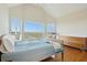 Bright bedroom featuring vaulted ceiling, hardwood floors and a scenic marsh view at 1676 E Ashley Ave, Folly Beach, SC 29439