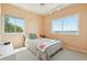 Bedroom features neutral carpet, two windows with a view, and a ceiling fan at 1676 E Ashley Ave, Folly Beach, SC 29439