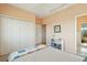 Well-lit bedroom with neutral walls and carpet has a large closet and an adjoining bathroom at 1676 E Ashley Ave, Folly Beach, SC 29439