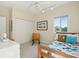 Cozy bedroom with a single bed, wooden chair, closet, and natural light from the window at 1676 E Ashley Ave, Folly Beach, SC 29439