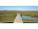 View of a private dock extending into the marsh, offering a serene waterfront escape at 1676 E Ashley Ave, Folly Beach, SC 29439