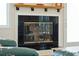 Living room featuring a fireplace with black tile and glass doors, wood mantle and hearth at 1676 E Ashley Ave, Folly Beach, SC 29439