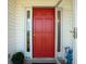Image of a red front door with sidelights and white trim at 1676 E Ashley Ave, Folly Beach, SC 29439