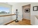 Hallway with hardwood floors, modern art, unique decor, and natural light from the windows at 1676 E Ashley Ave, Folly Beach, SC 29439