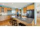 Spacious kitchen featuring a center island with seating, stainless appliances and wood cabinets with stylish accents at 1676 E Ashley Ave, Folly Beach, SC 29439