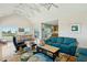 Living room with vaulted ceilings is open to dining and kitchen areas at 1676 E Ashley Ave, Folly Beach, SC 29439
