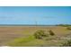 Beautiful view showcasing the marsh with a lighthouse in the distance on a sunny day at 1676 E Ashley Ave, Folly Beach, SC 29439